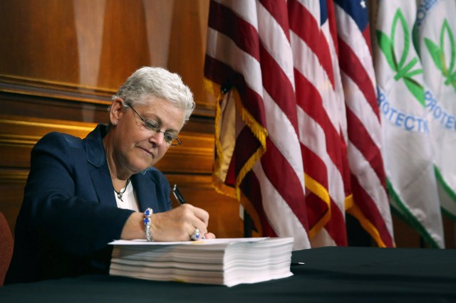 Gina McCarthy, the E.P.A. administrator, signed new regulations for power plants.